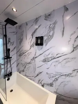 a bathroom with a white marble wall at Cozy 3 Bed Home, Free Parking 8 min to City Centre in Cowlairs