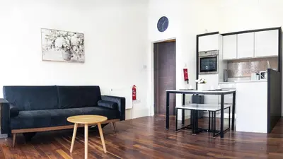 a living room with a couch and a kitchen at b&b in Edinburgh in Edinburgh