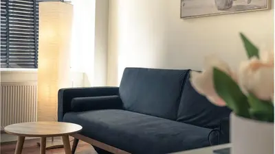 a living room with a blue couch and a table at b&b in Edinburgh in Edinburgh