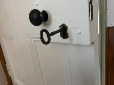a door with a black door knob on it at Crescent Corner 44 Seamore Street 3 Bedroom in Largs