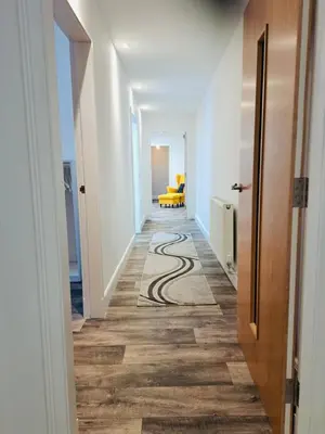 a hallway with a spiral pattern on the floor at Clyde Cottage in Lamington