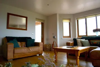a living room with two couches and a coffee table at Auchenhill Lodge in Denny