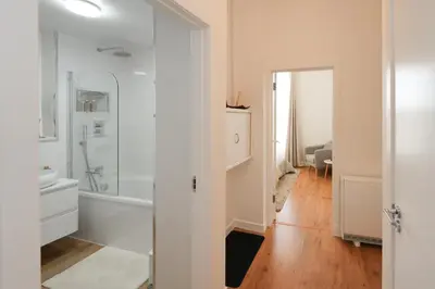 a bathroom with a white tub and a sink at Central 1-bed flat - Walk to shops, pubs and station in Saltcoats