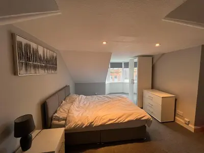 a bedroom with a bed and a dresser and a desk at Our Salad Days Lochgilphead in Lochgilphead