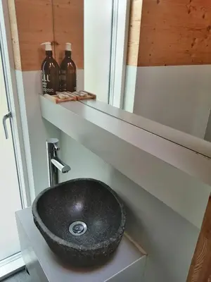 a bathroom with a black sink on a shelf at Red Kite Eco Bothy - with Hot Tub in Castle Douglas