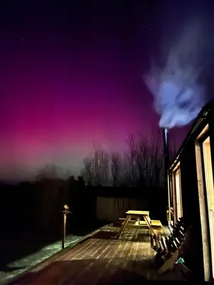 a picnic table at night with a pink sky at Red Kite Eco Bothy - with Hot Tub in Castle Douglas