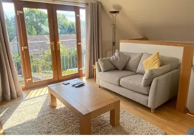 a living room with a couch and a coffee table at Loch Leven Loft in Milnathort