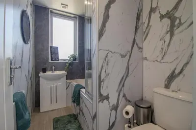 a bathroom with a sink toilet and a mirror at Highfield Apartment- 2 Bed in Motherwell close to centre in Motherwell