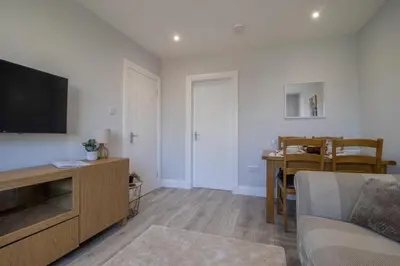 a living room with a flat screen tv and a couch at Highfield Apartment- 2 Bed in Motherwell close to centre in Motherwell