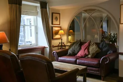 a living room with a couch and a table at The Royal Hotel in Comrie