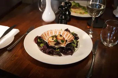 a plate of food on a wooden table at The Royal Hotel in Comrie
