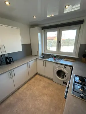 a kitchen with a sink and a washing machine at 3-Bed Apartment Central Greenock in Greenock