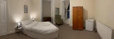 a bedroom with a bed and a dresser in it at Haymarket Flat in Edinburgh