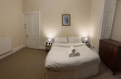 a bedroom with a bed with two towels on it at Haymarket Flat in Edinburgh