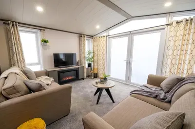 a living room with two couches and a tv at Crofthead Holiday Park in Ayr