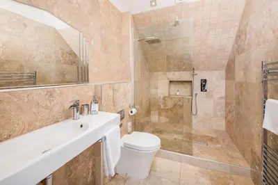 a bathroom with a toilet and a sink and a shower at Sequoia House in Tarbet