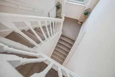an overhead view of a white spiral staircase at Large Terraced Home with Parking in Glasgow