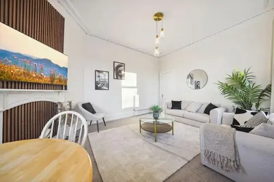 a living room with a couch and a fireplace at Large Terraced Home with Parking in Glasgow