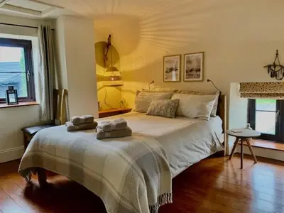 a bedroom with a bed with two towels on it at The Gower Cottages in Moffat