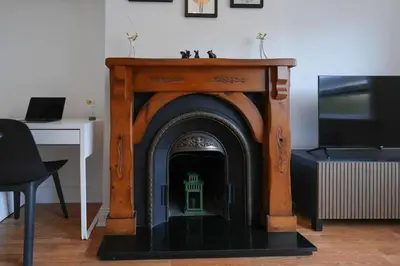 a fireplace with a table on top of it at Barassie Villa located near Troon in Troon