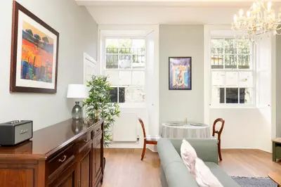 a living room with a couch and a table at Stylish 1-Bedroom Edinburgh Apartment in Edinburgh