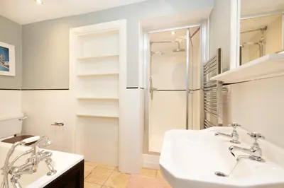 a bathroom with two sinks and a shower at Stylish 1-Bedroom Edinburgh Apartment in Edinburgh
