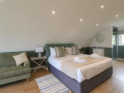 a bedroom with a large bed and a couch at Sula in Oban