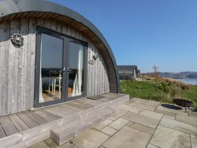 a house with a large window and a patio at WildLuing in Oban