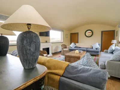 a living room with a couch and a lamp at WildLuing in Oban