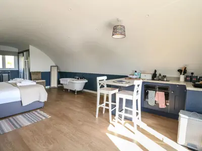 a bedroom with a bed and a sink and a tub at Scarba in Oban