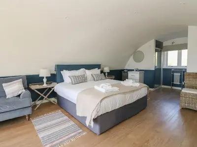 a bedroom with a large bed and a couch at Scarba in Oban