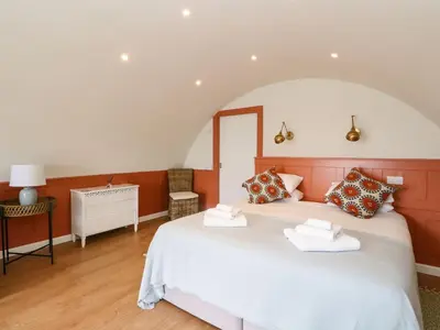 a bedroom with a large white bed in a room at Losal in Oban