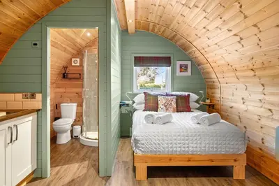 a bedroom with a bed and a bathroom at The Pods at 7 Black Crofts in Oban