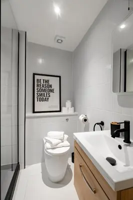 a white bathroom with a toilet and a sink at Hamilton Residence - Private Main Door 1BR in Glasgow