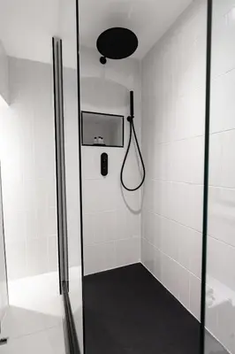 a shower with a glass door and a phone at Hamilton Residence - Private Main Door 1BR in Glasgow