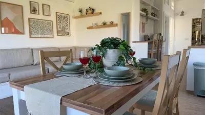 a dining room table with plates and wine glasses at The Tummel Lodge with Hot Tub in Crieff in Crieff