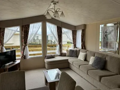 a living room with a couch and a tv at New Hampton 36 in Dunoon