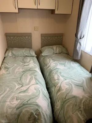 two beds sitting next to each other in a trailer at New Hampton 36 in Dunoon