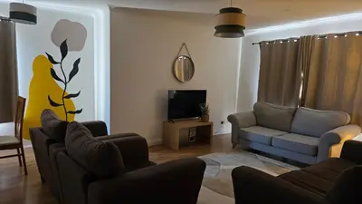 a living room with a couch and a tv at The Ansi9 in Livingston