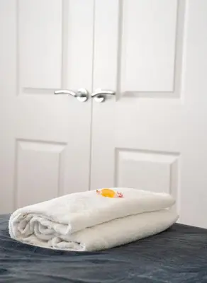 a pile of towels sitting on top of a table at Bartonshill House in Glasgow