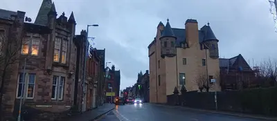 a city street with two large buildings with cars on it at Hotel Room in Maybole for Work Travel & Leisure in Maybole