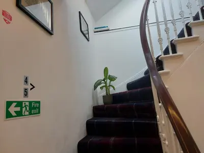 a staircase in a house with a plant on the wall at Hotel Room in Maybole for Work Travel & Leisure in Maybole