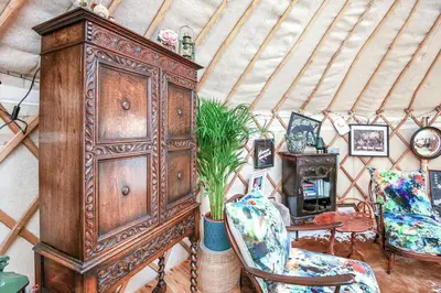 a room with a large wooden cabinet with a potted plant at Magical Quirky Romantic Yurt in Balquhidder in Balquhidder