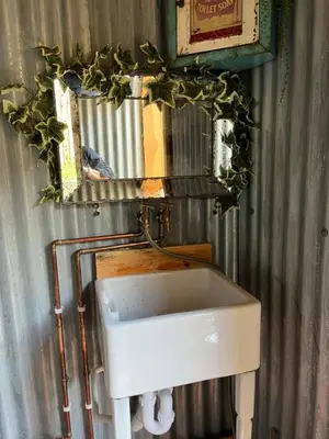 a bathroom with a sink and a mirror at Magical Quirky Romantic Yurt in Balquhidder in Balquhidder