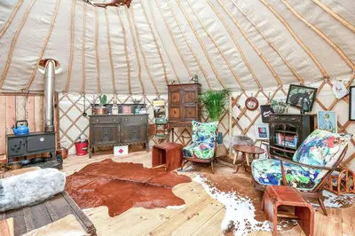 a living room with a yurt with chairs and furniture at Magical Quirky Romantic Yurt in Balquhidder in Balquhidder