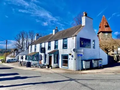 a large white building on the side of a street at The Clachan Inn in Dalry