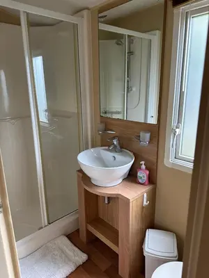 a bathroom with a sink and a shower at The Grosvner 61 in Dunoon
