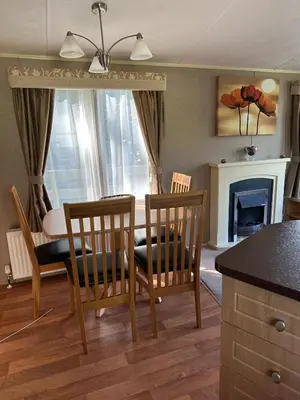 a living room with a table and two chairs and a dining room at The Grosvner 61 in Dunoon