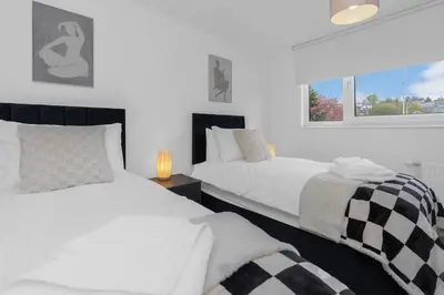 a bedroom with two beds and a window at Appin House -Cosy 2 bed house in Dunfermline in Dunfermline