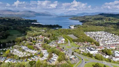 an aerial view of a town with a lake at 2 Bedroom in the Heart of Loch Lomond in Balloch
